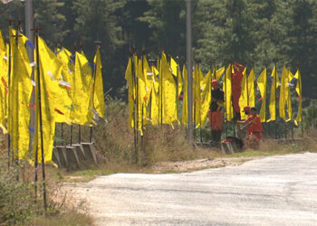 DeSuups hoist Zhabten flags