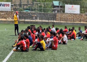 Youths undergoing grassroots football coaching in Paro