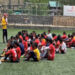 Youths undergoing grassroots football coaching in Paro