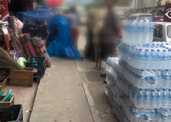 Pedestrians and businesses compete for space on Thimphu footpaths